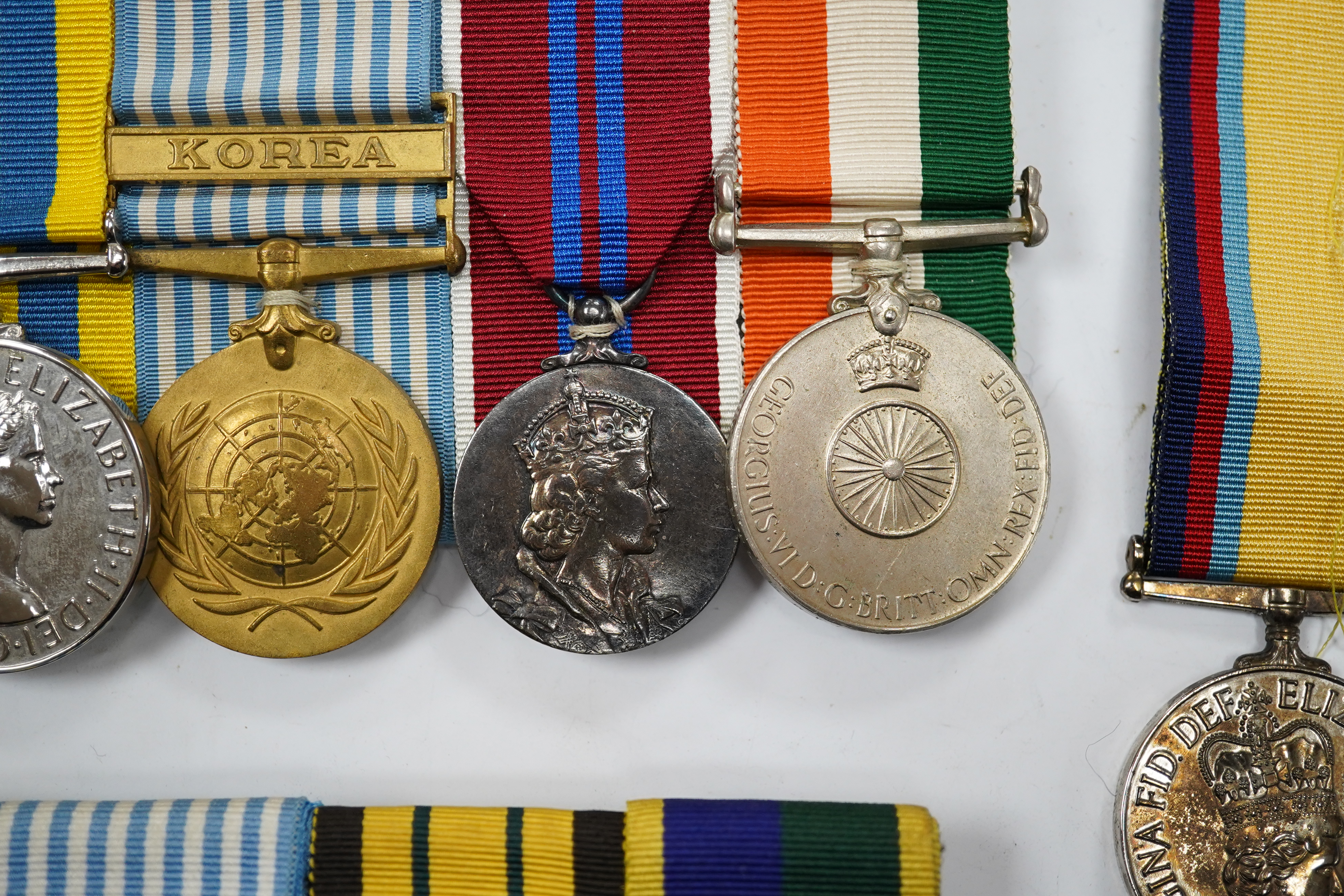 Twelve ERII and George VI medals, some medals arranged into two medals groups (containing unnamed medals and medals awarded to different recipients within the same group), including